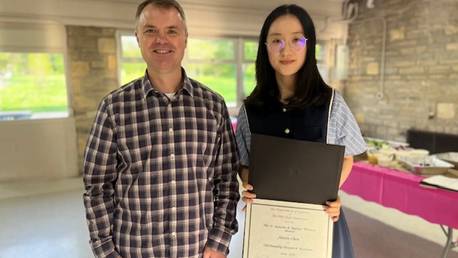 Chris Hans and Whitney RA Award recipient Jiaxin Chen standing together holding a certificate