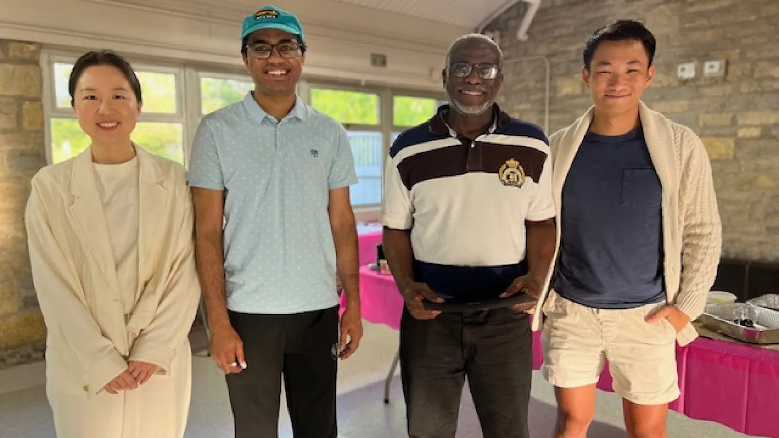 Yue Ma, Arko Gupta, Michael Jeter, and Alan Gan standing together in a pavilion